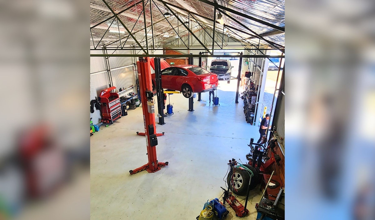 MD Auto Care workshop interior with car on hoist